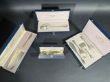 three silverware items in a blue case on a table