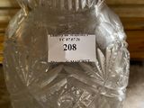 a glass vase with a label on it sitting on a table