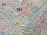 a close up of a painting of flowers on a wall