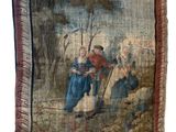 an old tapestry hanging on a wall with a painting of a man and a woman
