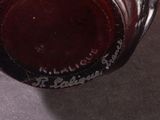a wine glass with a red liquid inside of it