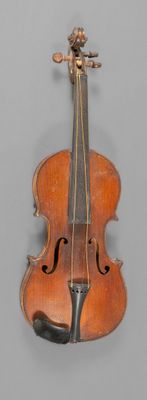 an old violin sitting on top of a table next to a wall