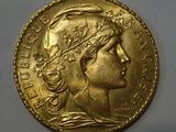a close up of a gold coin with a woman ' s head on it