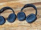 two headphones that are sitting on a wooden table