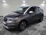 the grey opel is parked in a room with a checkered floor