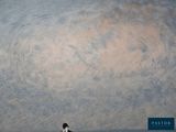 a man that is standing in the water with a surfboard