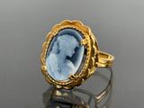 an image of a gold ring with a blue cameo of a woman