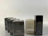three boxes of perfume sitting on top of a white table