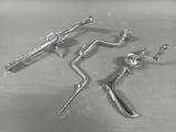 three metal tools are sitting on a table with a white background