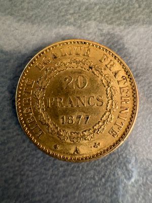 a close up of a gold coin on a white surface