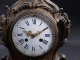 a clock with roman numerals on the face of it