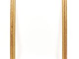 a gold frame on a white wall with a white background