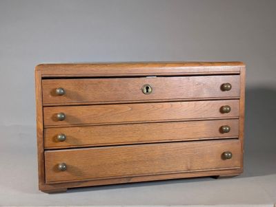 an image of a wooden chest of drawers on a table