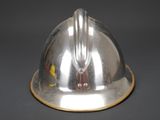 a silver helmet that is sitting on a table