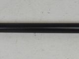 a close up of a black pen on a white surface