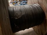 a spool of black wire on a reel in a room