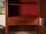 a wooden cabinet with a red and white pattern on it