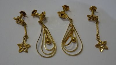 three pairs of gold earrings and a pair of earrings