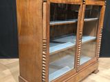 a wooden display cabinet with glass doors and drawers