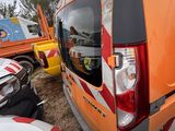 an orange van that is parked next to other vehicles