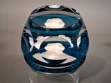a blue glass bowl with a fish design on it