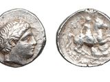 a close up of a coin with a face on it