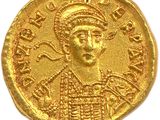 a close up of a gold coin on a white surface