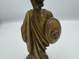 bronze statue of a roman soldier holding a shield and shield