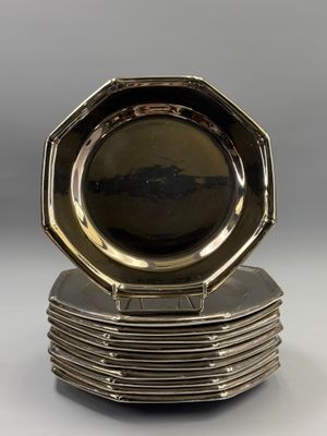 a set of six silver plated dishes on a stand