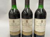 three bottles of wine sitting on top of a table next to each other