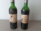 two bottles of wine sitting next to each other on a table