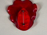 a red hat sitting on top of a red flower