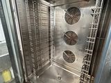 a metal oven that has a lot of food inside of it