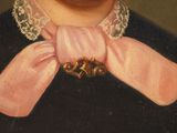 portrait of a man wearing a pink bow tie and a black shirt