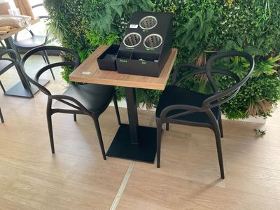 a small table with two chairs and a clock on it