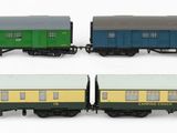 four toy train cars are lined up on a white surface