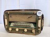 an old radio sitting on a table with a price tag on it