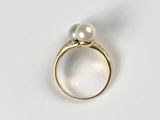 an image of a gold ring with a pearl on top of it