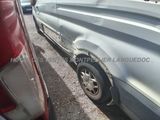 an image of a car that has been damaged and is parked on the side of the road