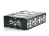 three boxes of ocb rolling papers sitting on top of each other