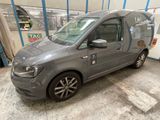 the grey van is parked in the garage in front of a building
