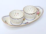 two cups and saucers sitting on a plate