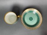 a close up of a cup and saucer on a table