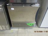 two stainless steel refrigerators sitting next to each other in a room