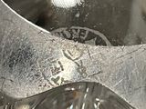 a close up of a metal object with a spoon in it