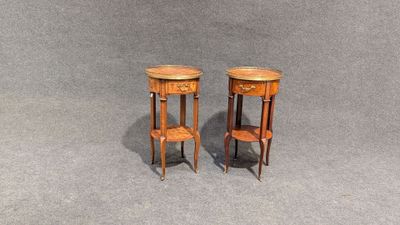 pair of small wooden side tables on a grey background