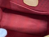 a red purse with a gold zipper on the inside