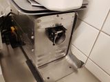 a white bowl on top of a machine in a kitchen
