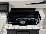 a close up of a printer sitting on top of a white table