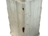 a white vase sitting on a white surface with a white background